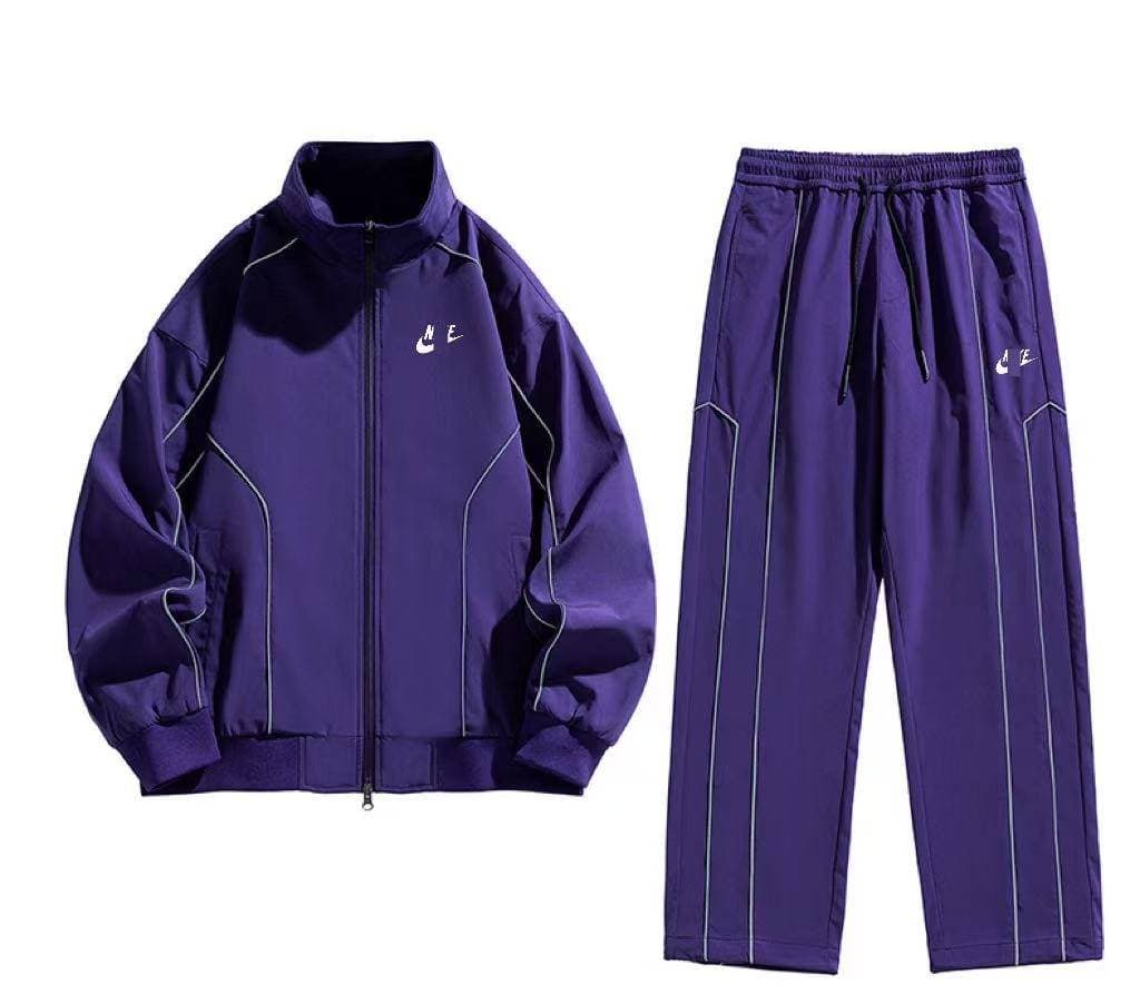 Ensemble de sport 2 pièces pour homme Nlke : veste zippée à bandes contrastées et pantalon large.