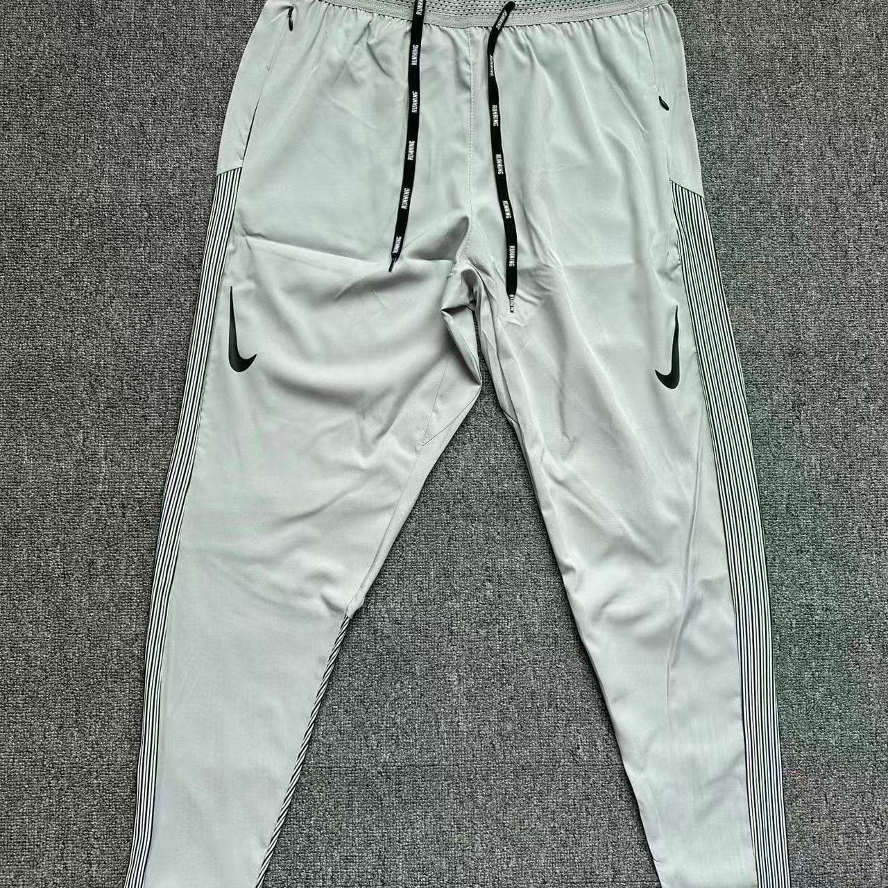 Pantalon de sport à séchage rapide pour homme et femme, respirant, coupe droite, idéal pour la course à pied et le marathon. Fermeture éclair.