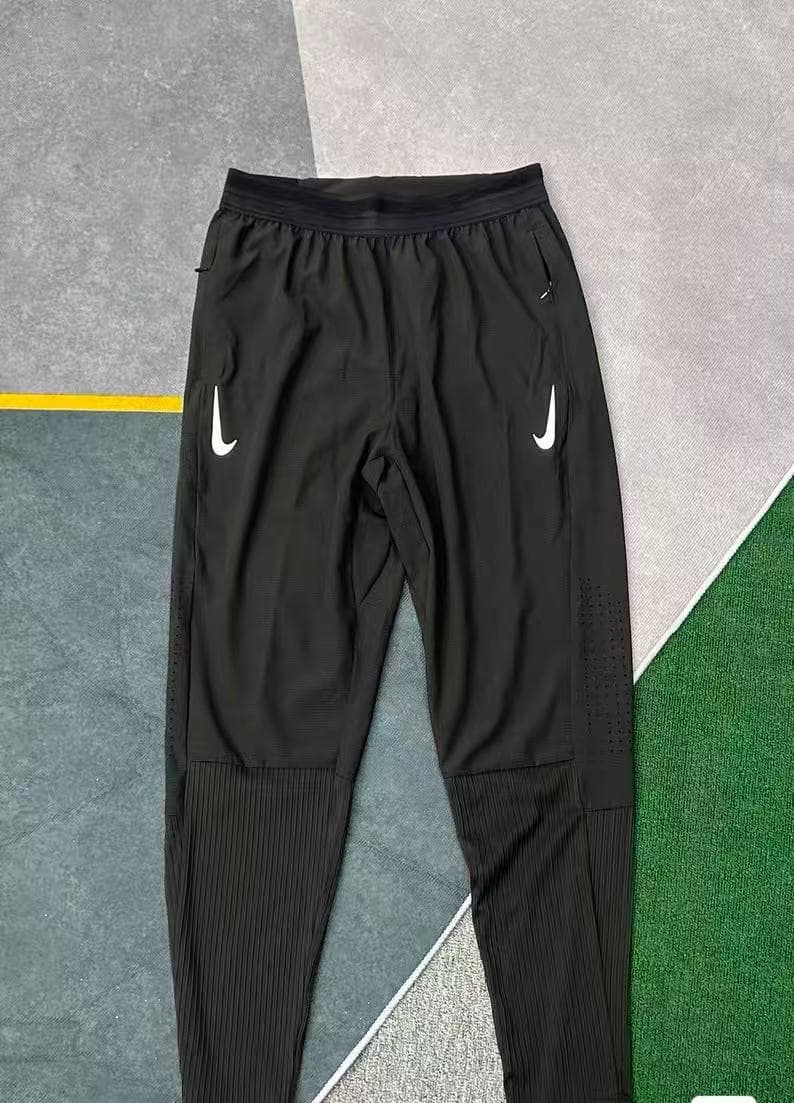 Pantalon de running Nike Dri-FIT pour homme, séchage rapide, logo Swoosh réfléchissant, ourlet côtelé, poches zippées, noir