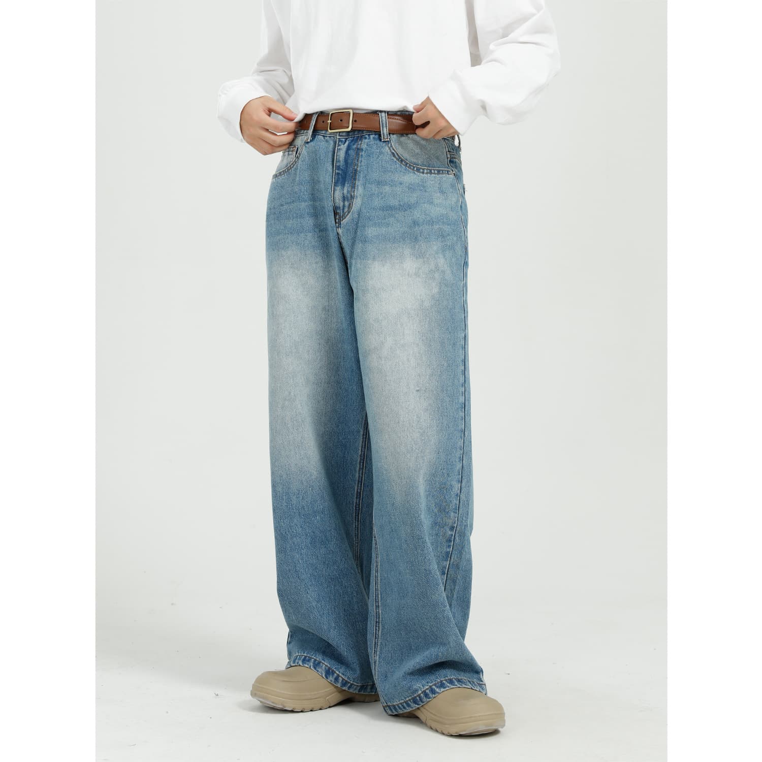 Men's outfit is baggy with blue straight leg wide-leg jeans