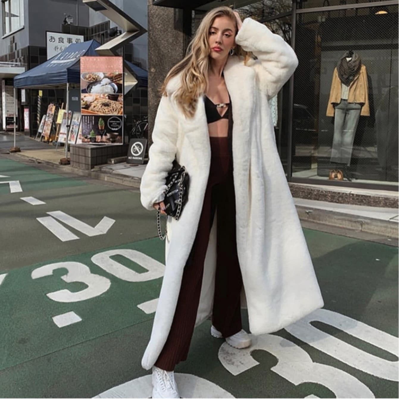 Women street fashion warm faux fur coat with belt.